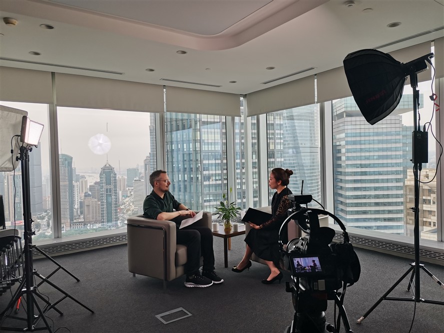 Wuxi production crew reviewing a shoot on location